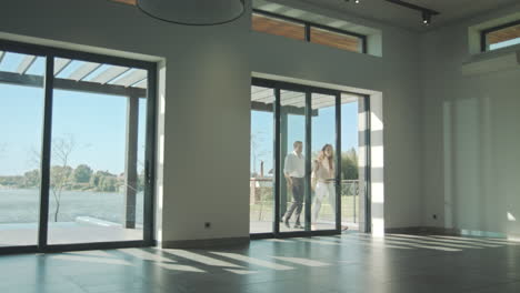 happy couple entering modern home