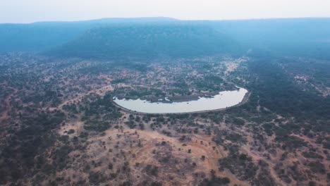aerial drone shot of a stop dam in a forest of india