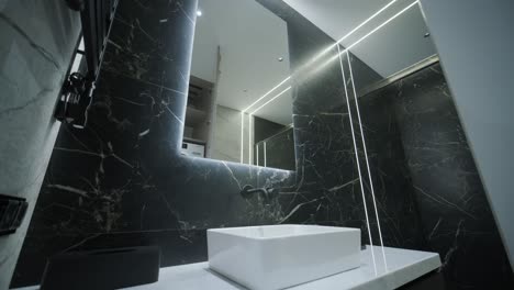 contemporary bathroom with marble accents and vertical lighting