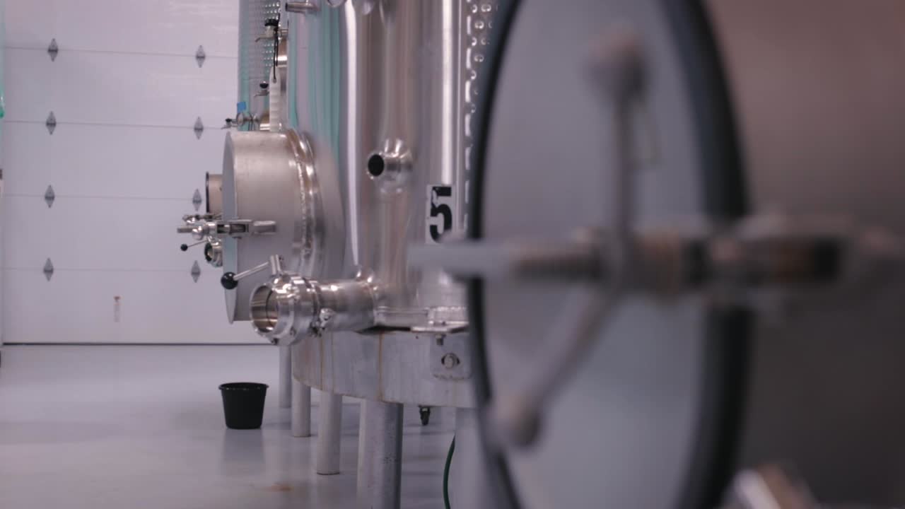 Stainless steel wine tanks used to store wine during wine making process coming into focus