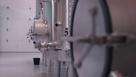 stainless steel wine tanks used to store wine during wine making process coming into focus
