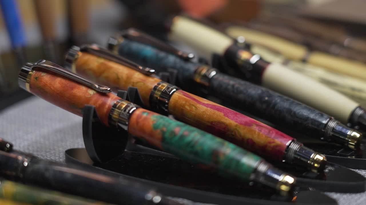 Display of handcrafted pens on a table