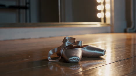 ballet pointe shoes on wooden floor