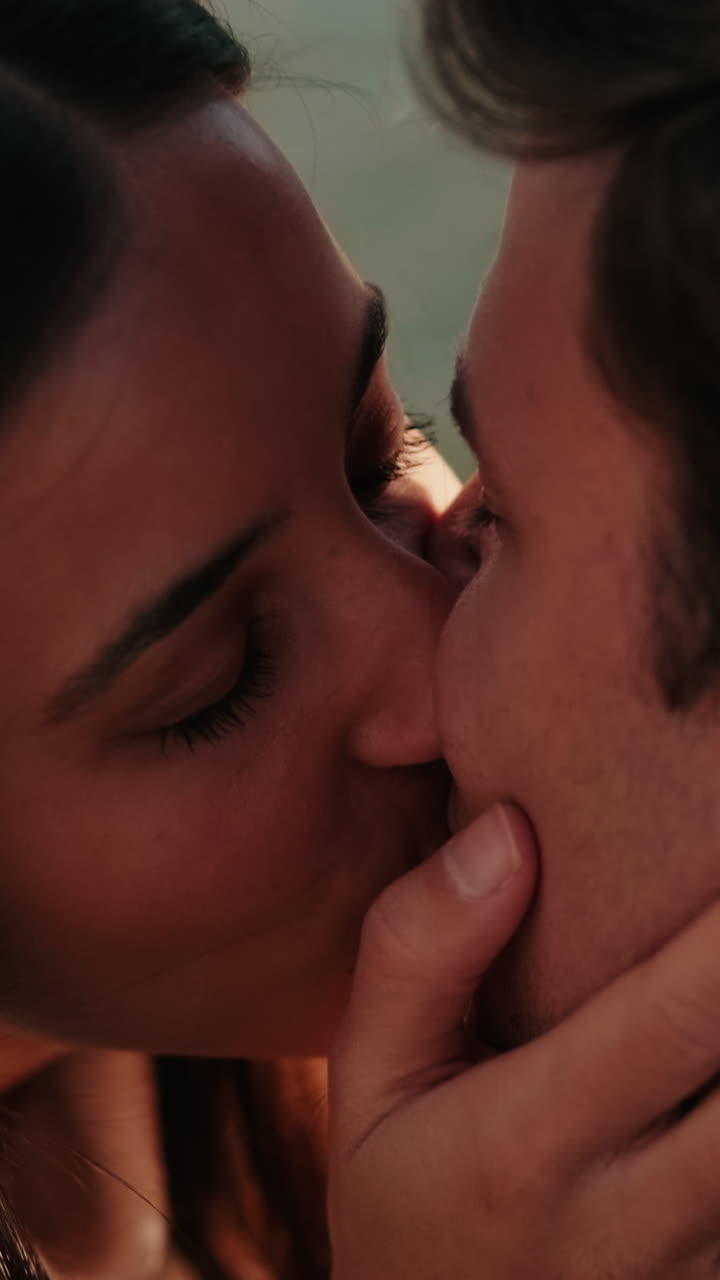 Young Couple's Tender Kiss by the Water