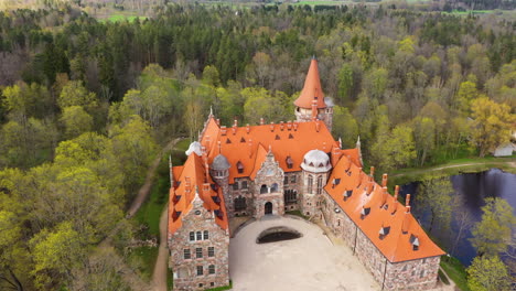 panoramic aerial view of cesvaines palace surrounded with green forest