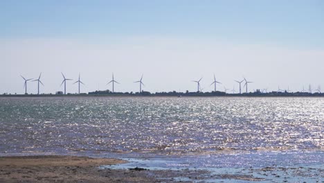 windfarm on land looking across the water