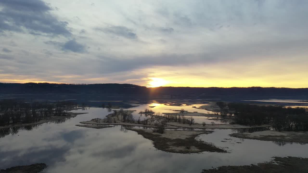Aerial View of Serene River Wetlands at Golden Hour Sunset