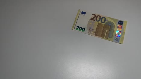 flying 200 euros banknote on a white background in slowmotion