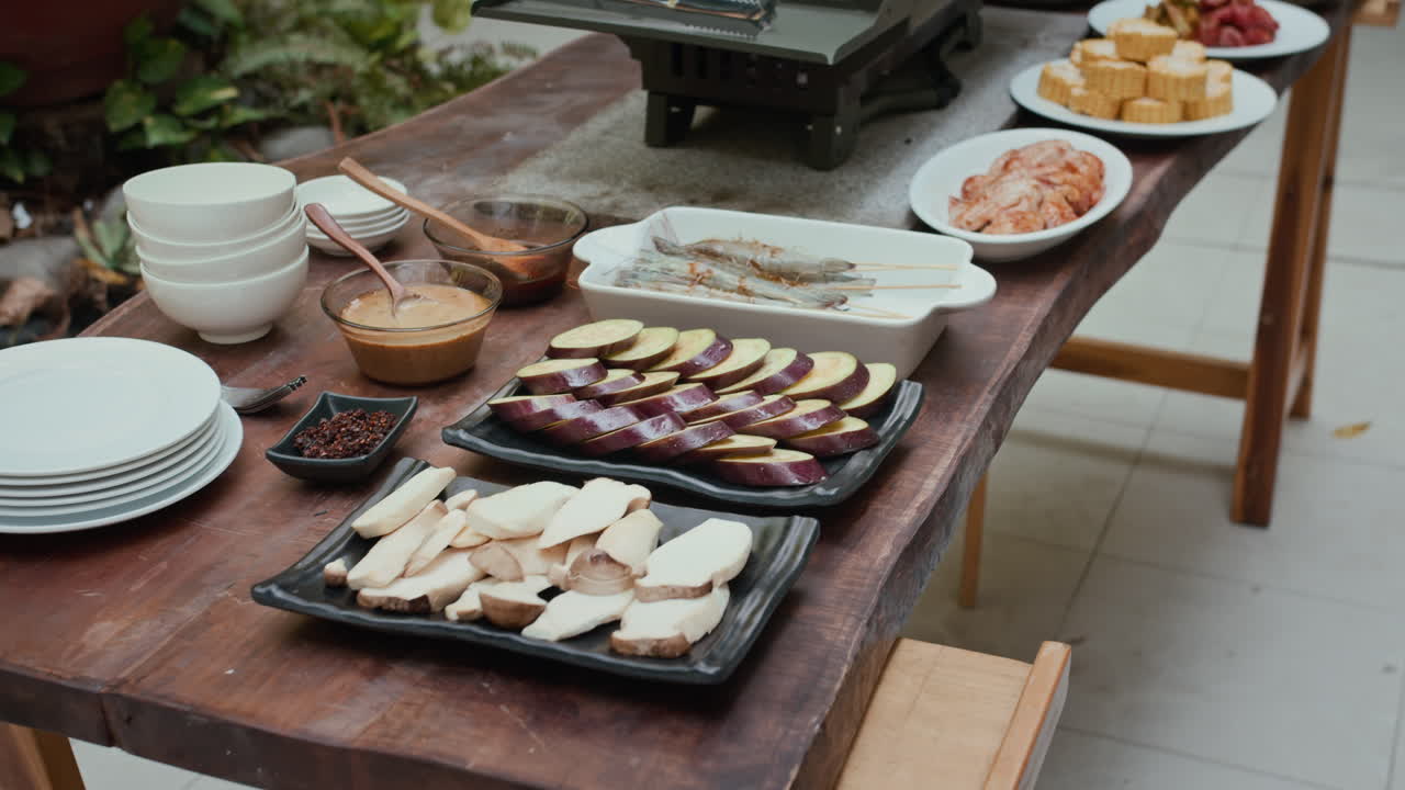 Raw Slices of Vegetables, Sauces and Meat for Grill on Table at Backyard