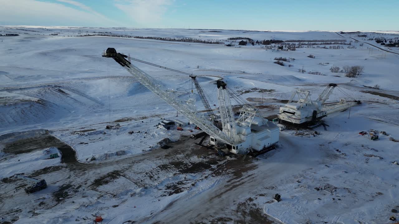 4K Drone video of snowy white mining crane in North Dakota with