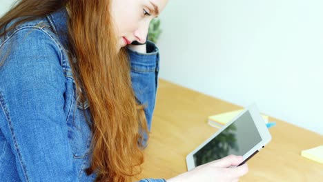 tense business executive using digital tablet