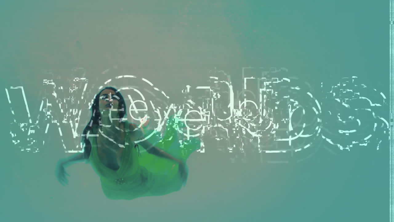 Swimming underwater, woman with glitch text animation overlaying scene