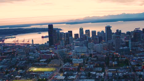 seattle first hill downtown skyline orange color clouds sunset elliott bay waterfront san juan islands olympic mountains background