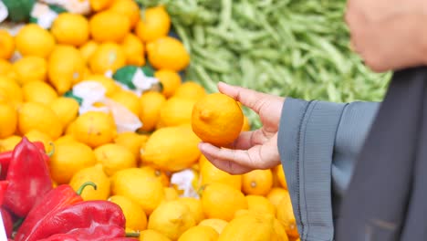 Woman buying lemons at a market