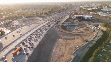 aerial-time-lapse-of-the-busy-405-freeway-during-rush-hour-with-stop-and-go-traffic-and-cars-merging-on-and-off-the-ramps-amidst-the-bustling-cityscape
