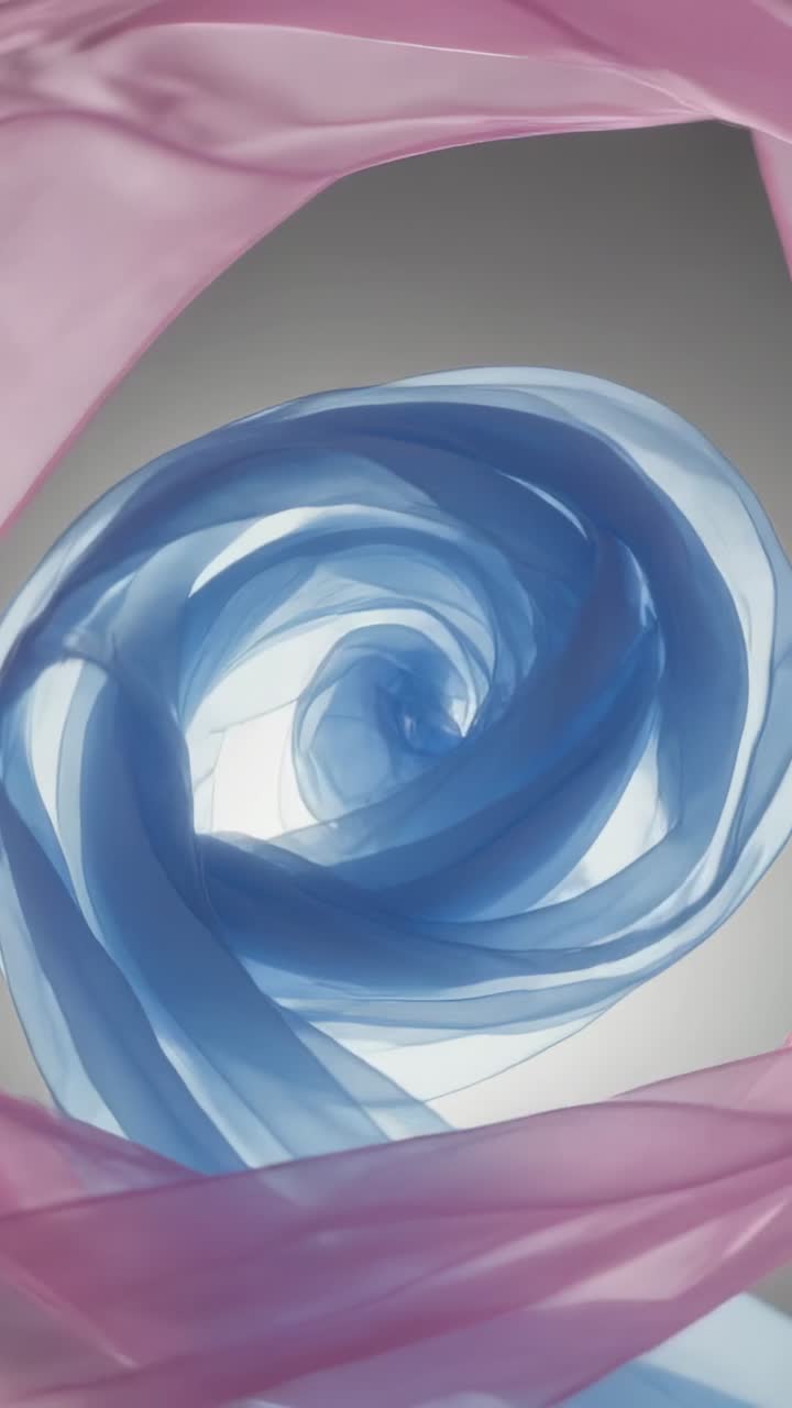 Video verticale: Spirale di nastro blu reagisce mentre sciarpe rosa fluttuano all'interno, ruotando e aprendosi per la moda.