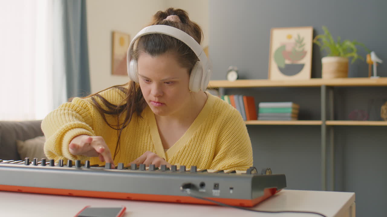 Female Musician with Down Syndrome Playing Synthesizer