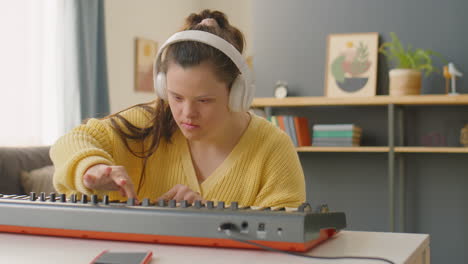 female musician with down syndrome playing synthesizer