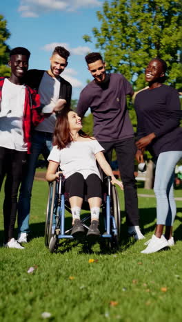 diverse group of friends enjoying a sunny day in the park, including a friend in a wheelchair