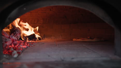 pizza slowly cooking in the wood oven at the restaurant