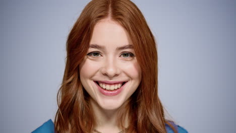 charming woman looking at camera indoors. girl raising eyes at lens in studio