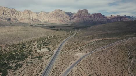 Flying-along-road-in-the-Nevada-desert-with-mountains-in-the-background