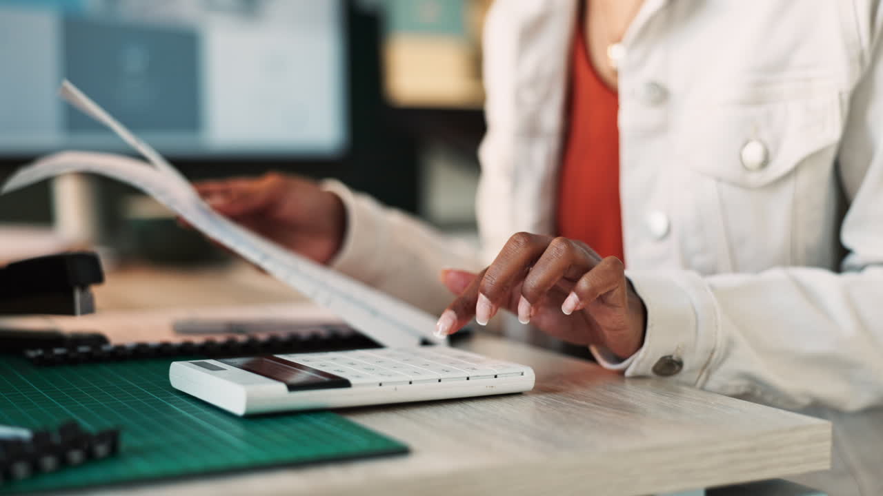 Woman using calculator at desk