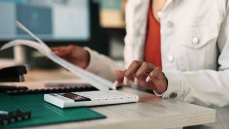 woman using calculator at desk