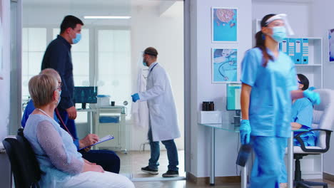 Man-discussing-with-nurse-at-hospital-reception