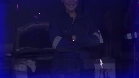 woman mechanic standing arms crossed in automotive workshop, featuring animated engine data charts