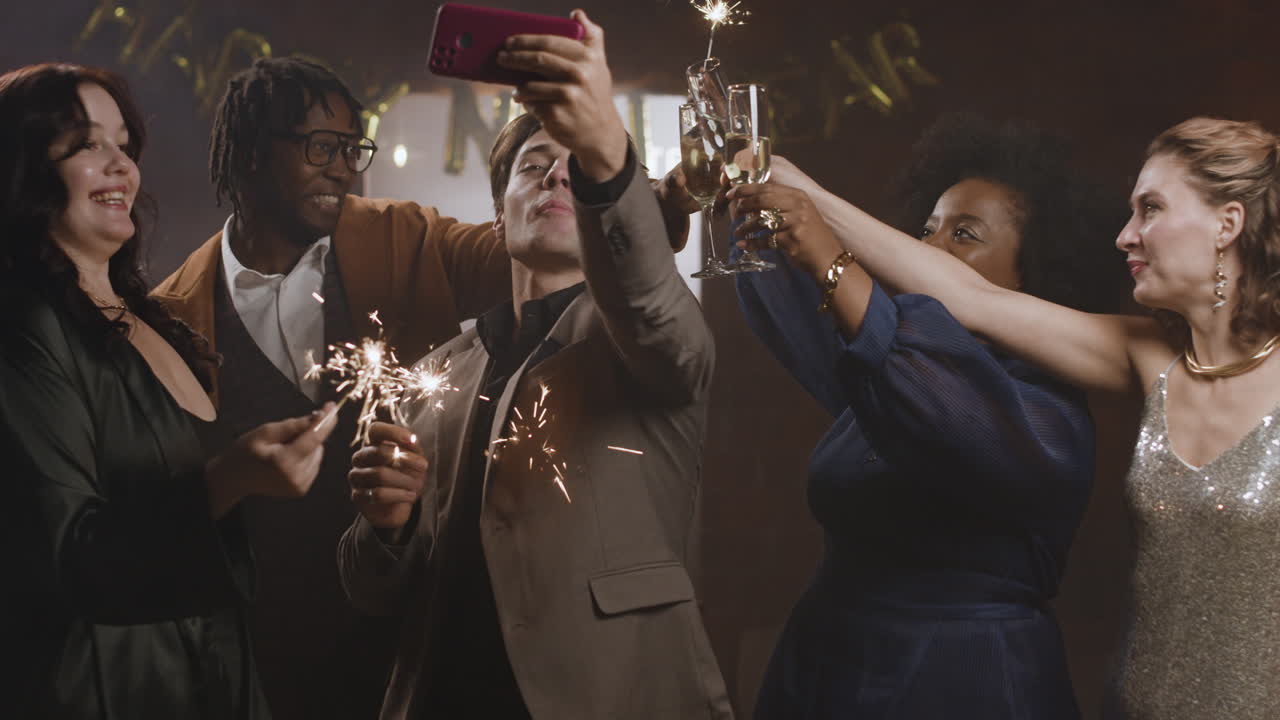Group of friends celebrating with sparklers and champagne