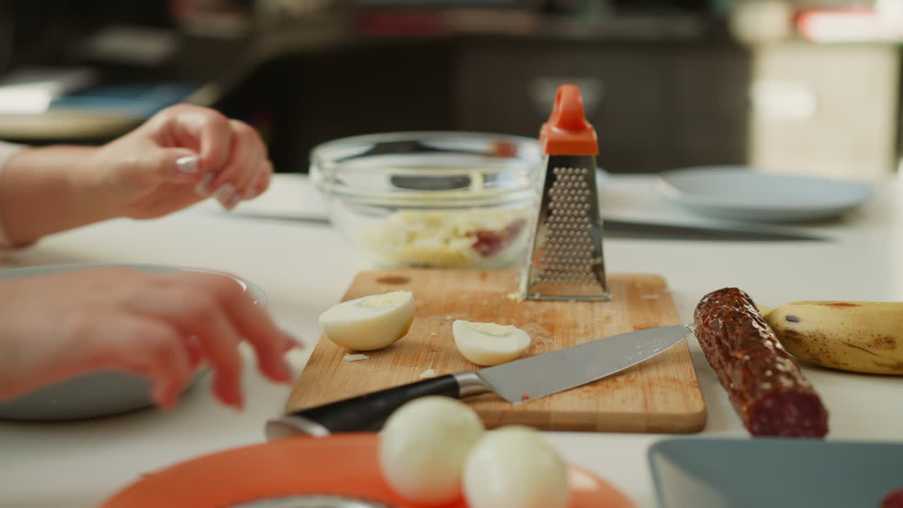 Preparing a Salad with Eggs and Sausage