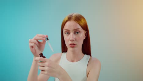 woman applying face serum