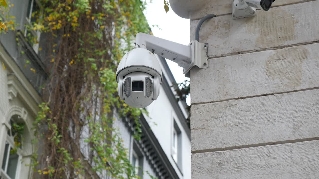 White Security Camera Mounted on a Building Wall