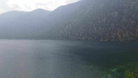 Coast-mountains-of-British-Columbia-surrounding-Pavilion-Lake-on-a-smoky-day-during-wildfire-season