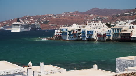 Windy-Day-on-Bay-in-Mykonos-Town,-Greece-with-Cruise-Ships-in-BG