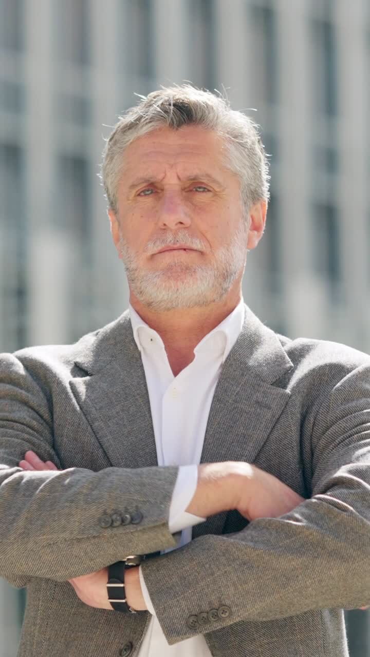 Portrait of a mature man with a beard and crossed arms