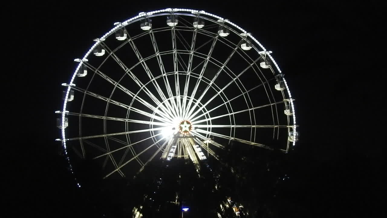 밤에 놀이공원의 야경, 밤하늘을 배경으로 축제의 푸른 조명이 있는 대관람차, 유명한 관광 명소, 모로코의 아가디르 시