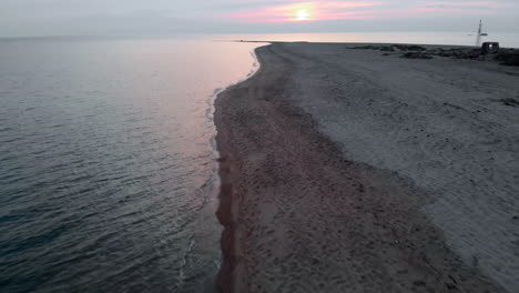 Drone-video-high-speed-sunset-over-empty-beach-summer-Greece-ascending-tilt-down