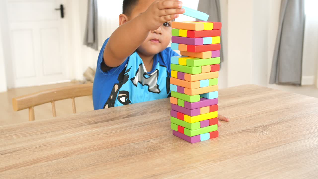 Little Boy Exciting To Play Wood Block Tower Game