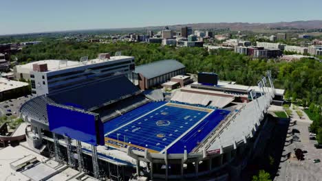 drone shot pulling away from boise state university's football stadium.