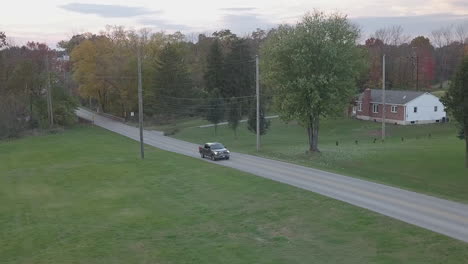 aerial tracking shot of cars on small town road