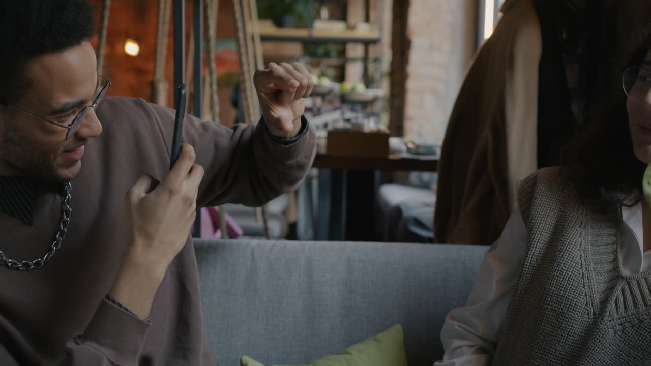 Friends taking selfies in a cafe