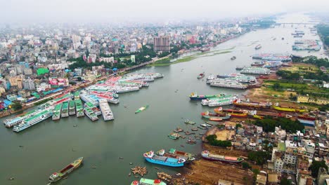aerial view of a city with a busy river and numerous ships