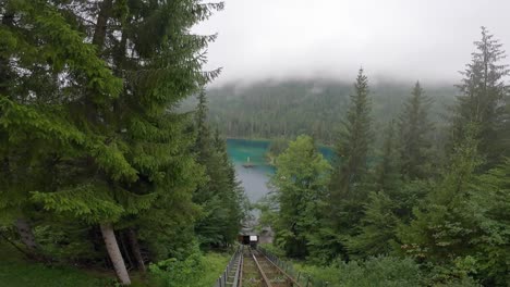 Gopro-view-of-a-cable-car-ascent-in-a-forest-next-to-a-sublime-alpine-lake-in-the-Swiss-Alps