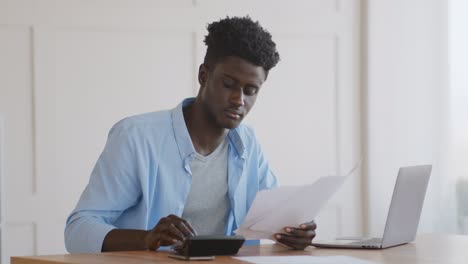 young african american man paying bills