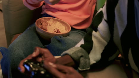 young man playing videogames at home