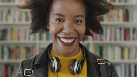 portrait african american woman student smiling bookshelf library university