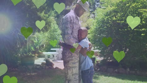animación de corazones sobre feliz soldado afroamericano padre abrazando a su hijo