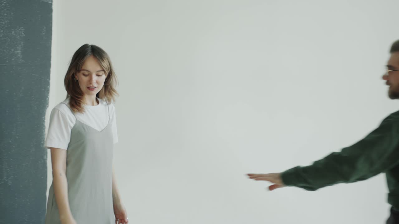 Photographer and Model Entering Photo Studio and Taking Pictures